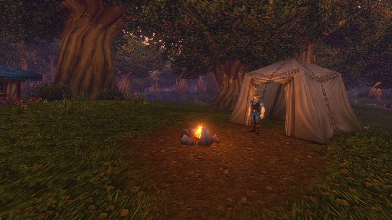 A campfire and tent at night